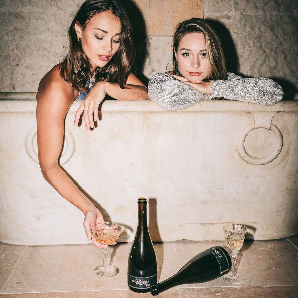 Two girls in luxurious bathtub enjoying LVST & FEAST