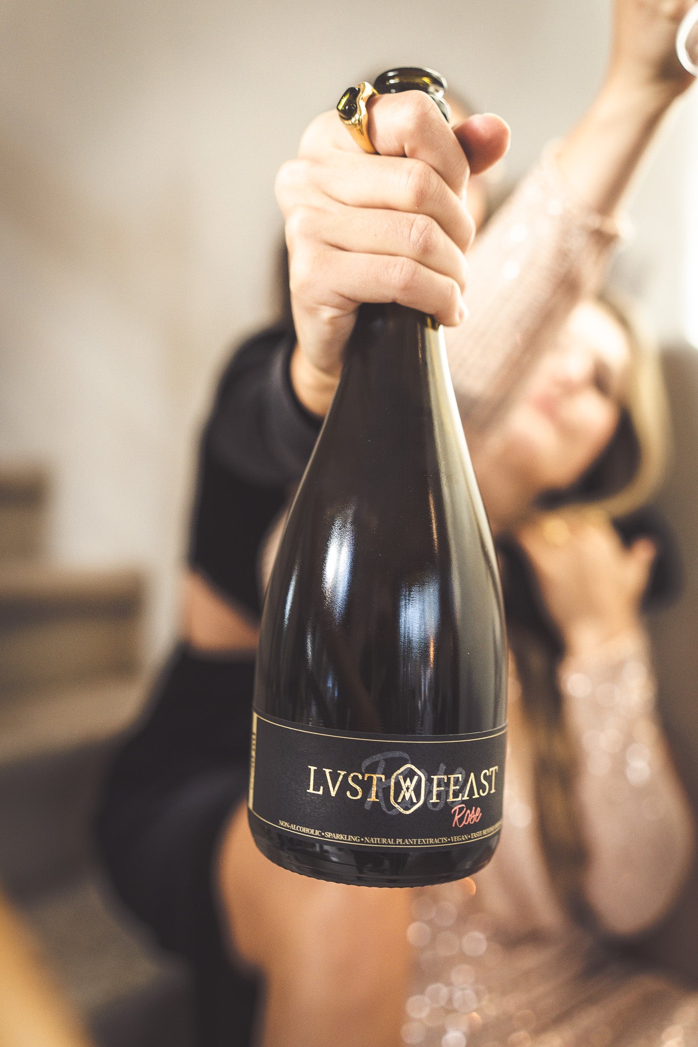 Woman with Bottle of LVST & FEAST refreshingly sparkling and taste beyond ordinary